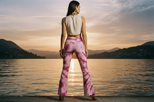 Pink tie-dye pants worn by a person on a white background