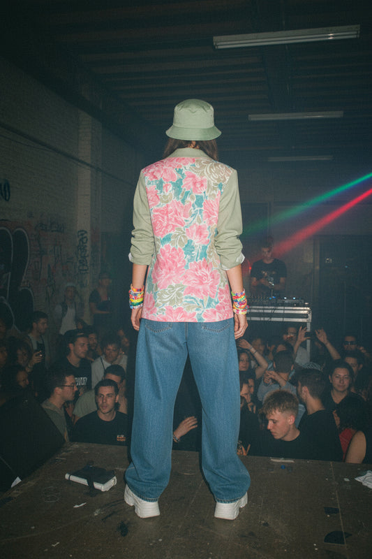 Floral patterned shirt with green collar on a white background